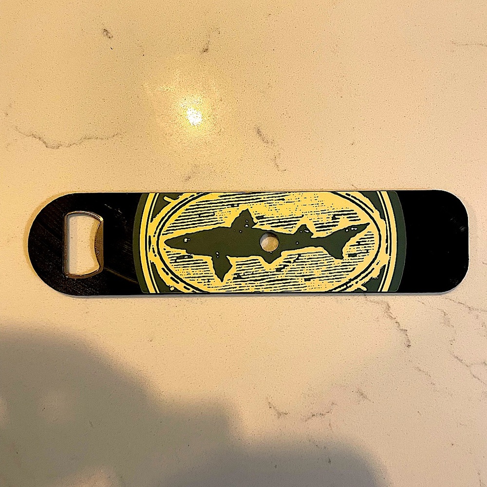 Dogfish Beer bottle opener. Green and black l. Double plated on each side.
